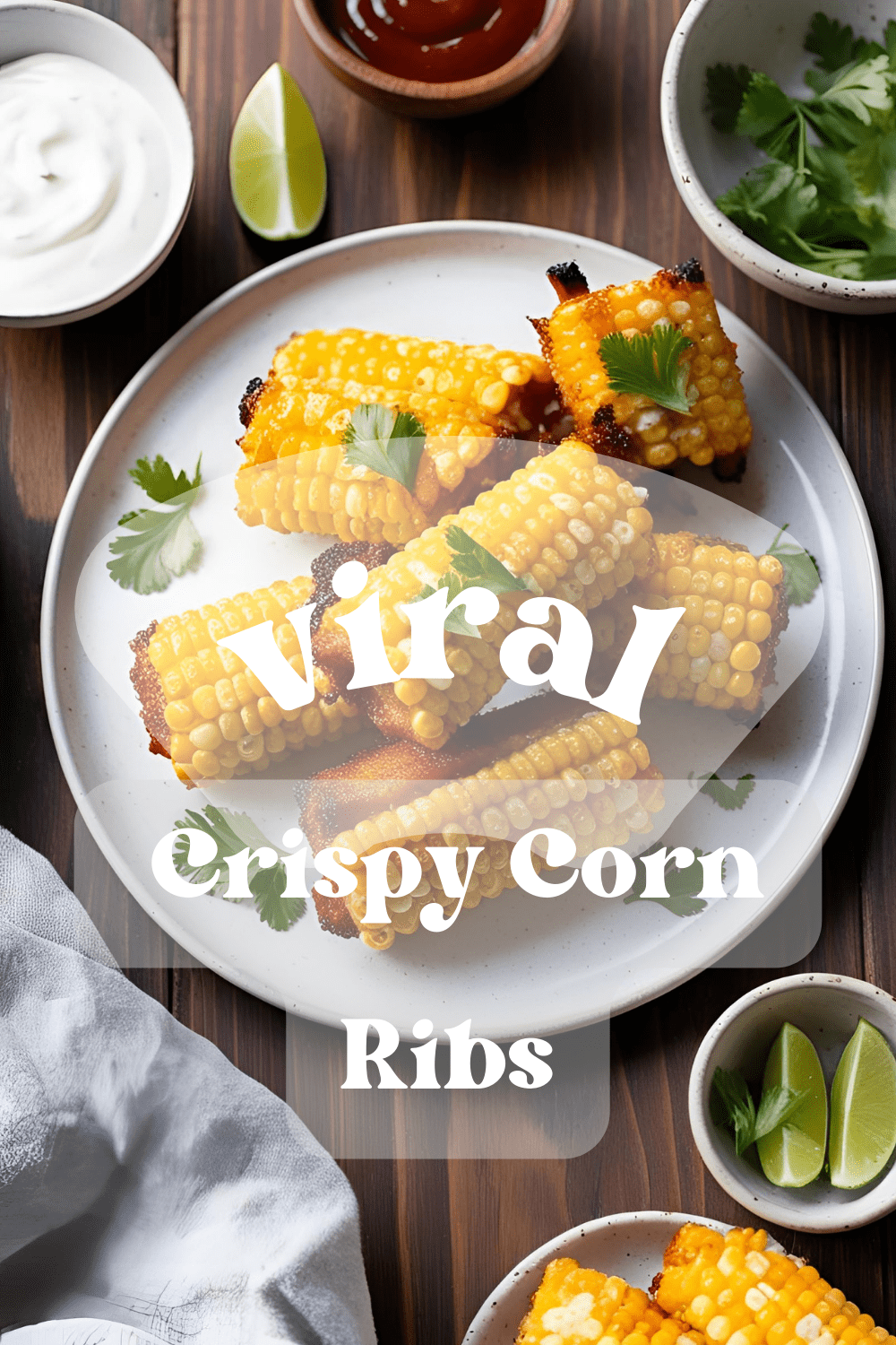 Close-up of crispy seasoned corn ribs with lime wedges on a plate