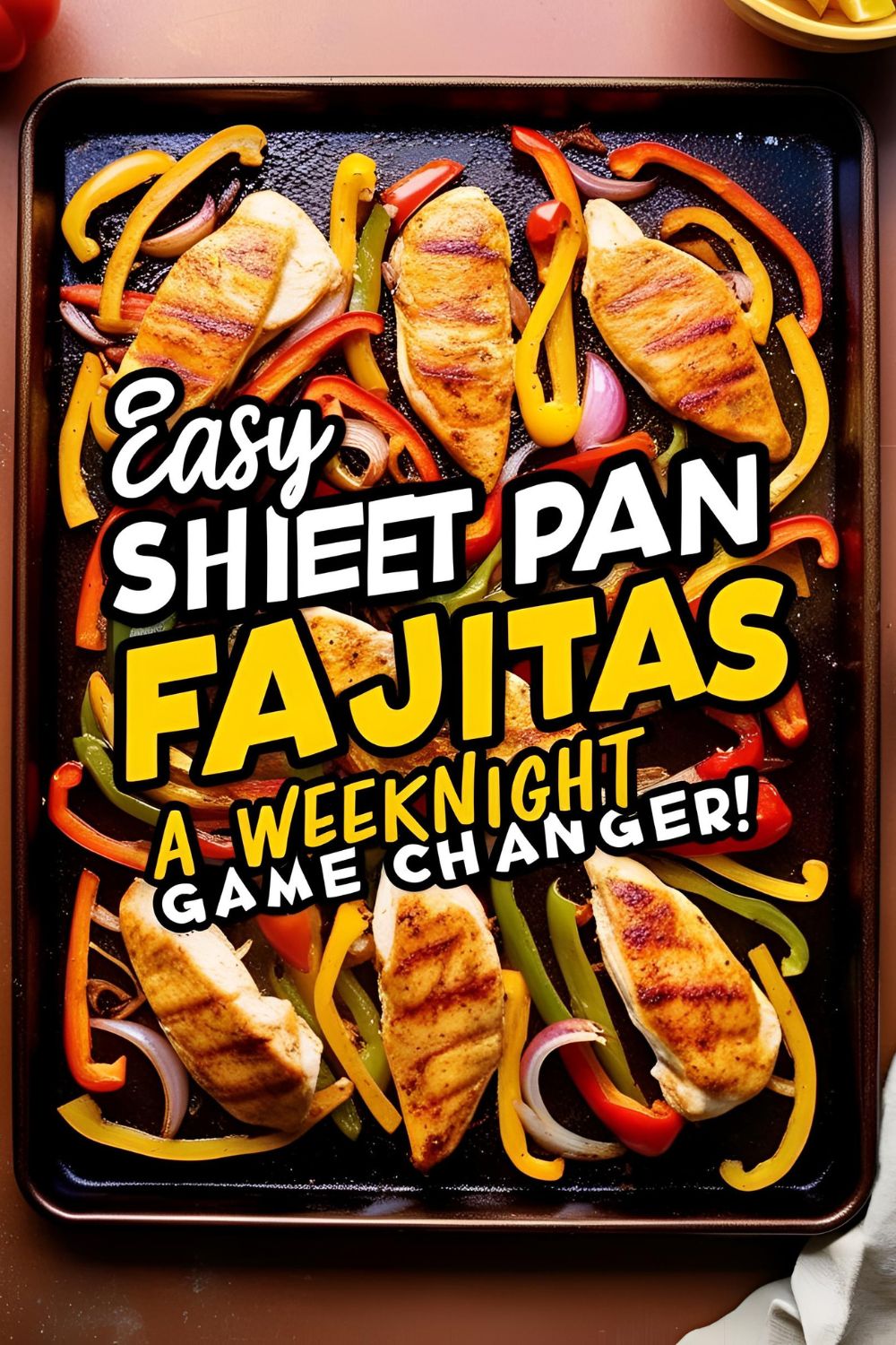 Sizzling sheet pan fajitas with chicken, bell peppers, and onions on a baking sheet.​