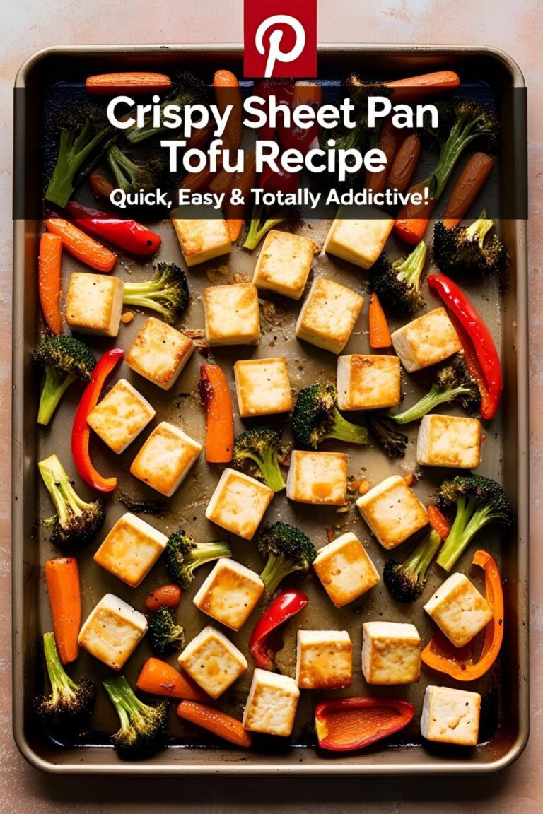 Crispy sheet pan tofu with roasted vegetables on a baking sheet