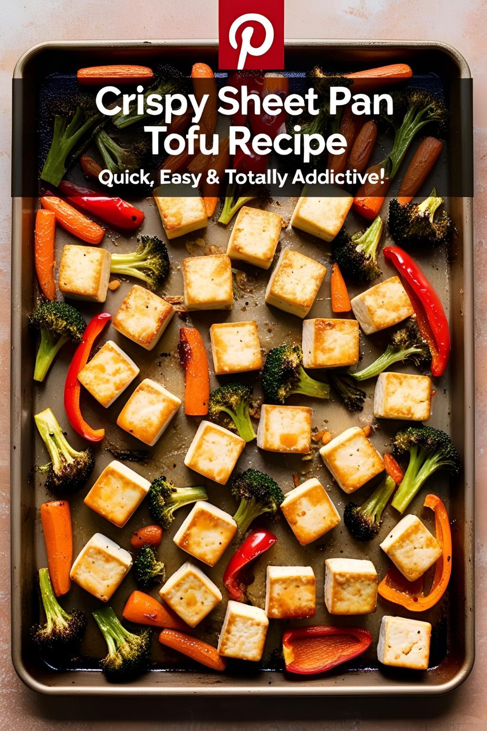 Crispy sheet pan tofu with roasted vegetables on a baking sheet
