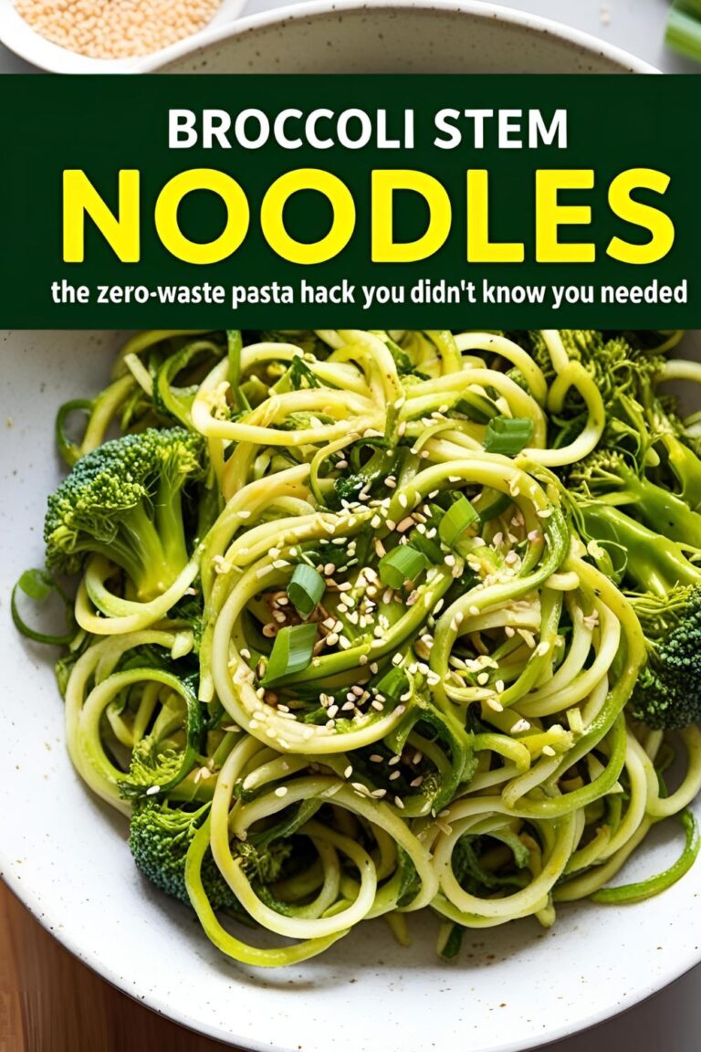 A bowl of broccoli stem noodles garnished with sesame seeds and green onions.