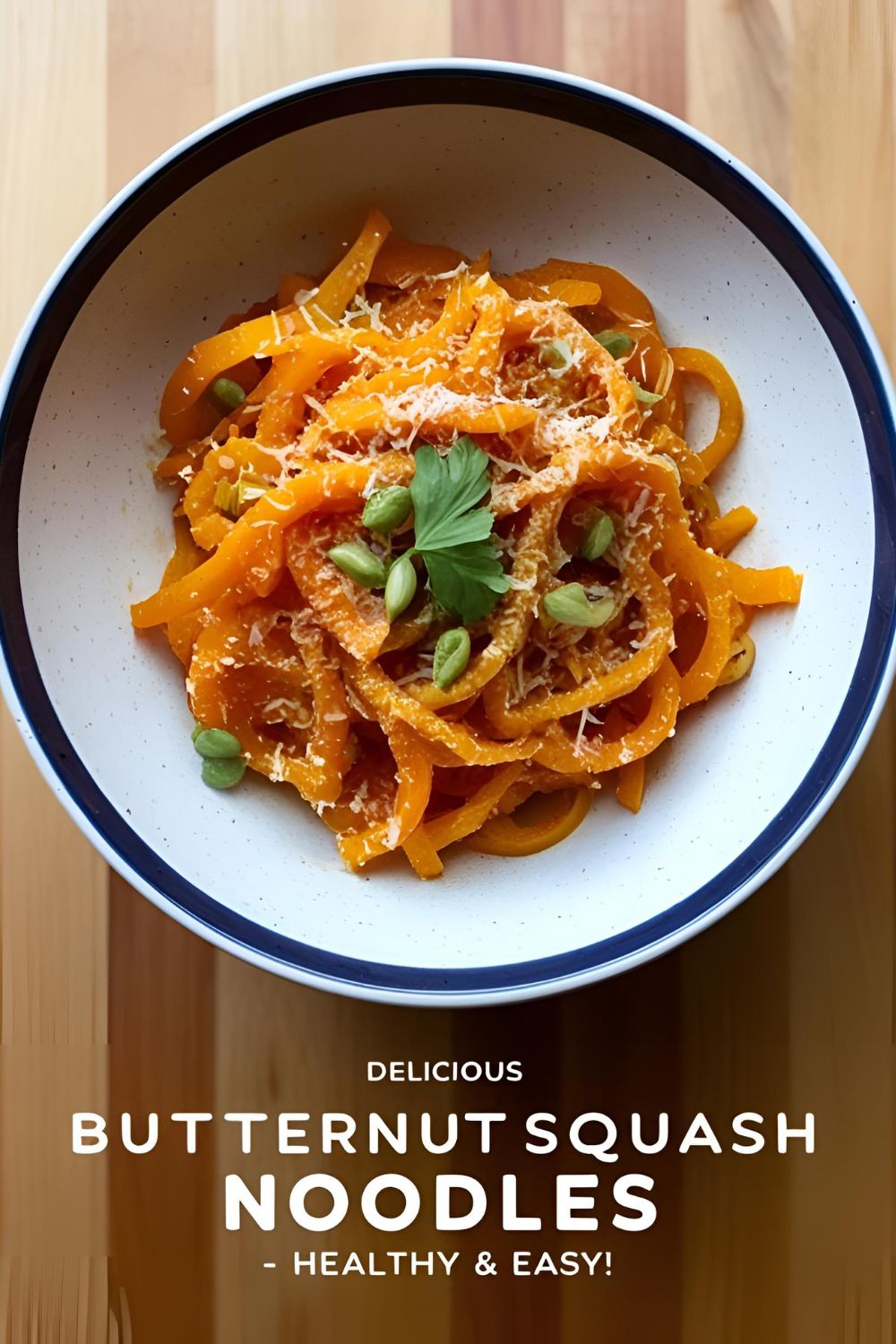 "Plate of butternut squash noodles garnished with herbs and Parmesan cheese