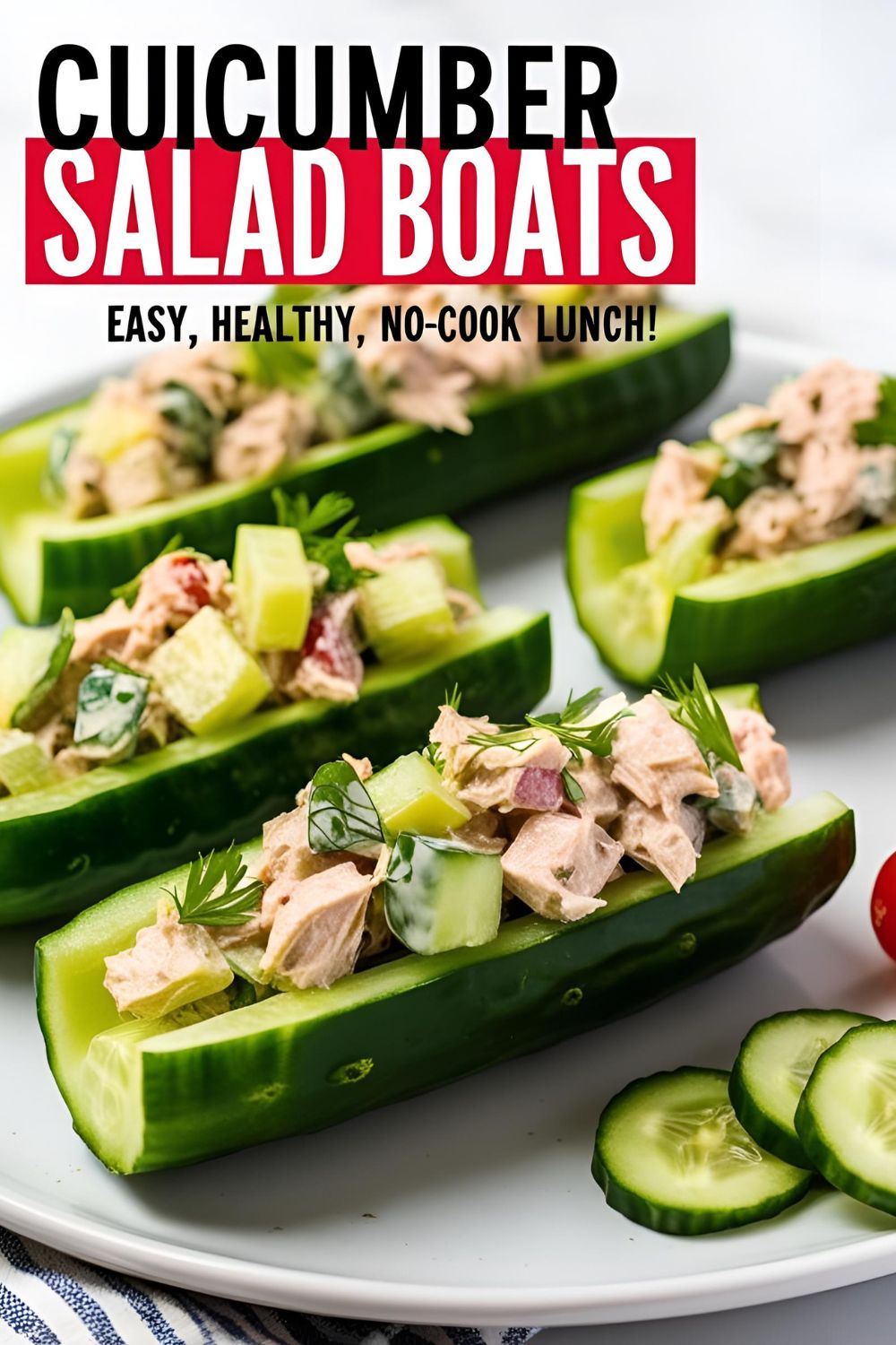 Cucumber Tuna Salad Boats arranged on a plate, garnished with fresh herbs.