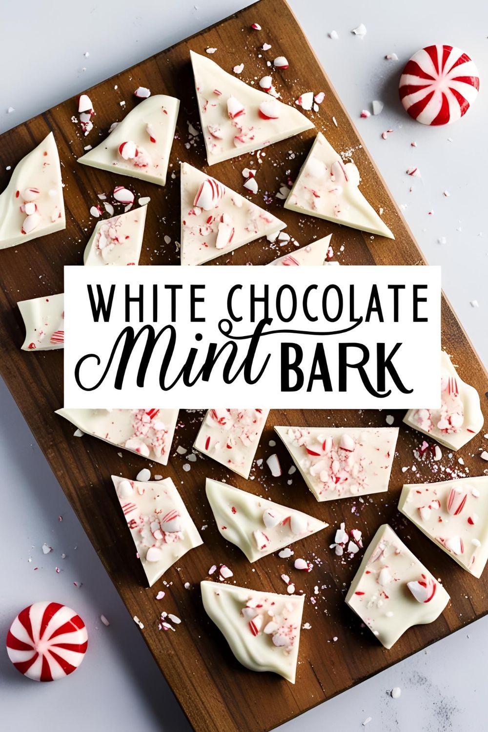 Close-up of white chocolate mint bark pieces sprinkled with crushed peppermint candies.