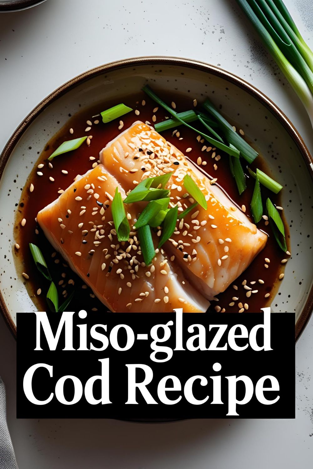 Glazed cod on a plate with garnish and text overlay showing miso-glazed cod recipe