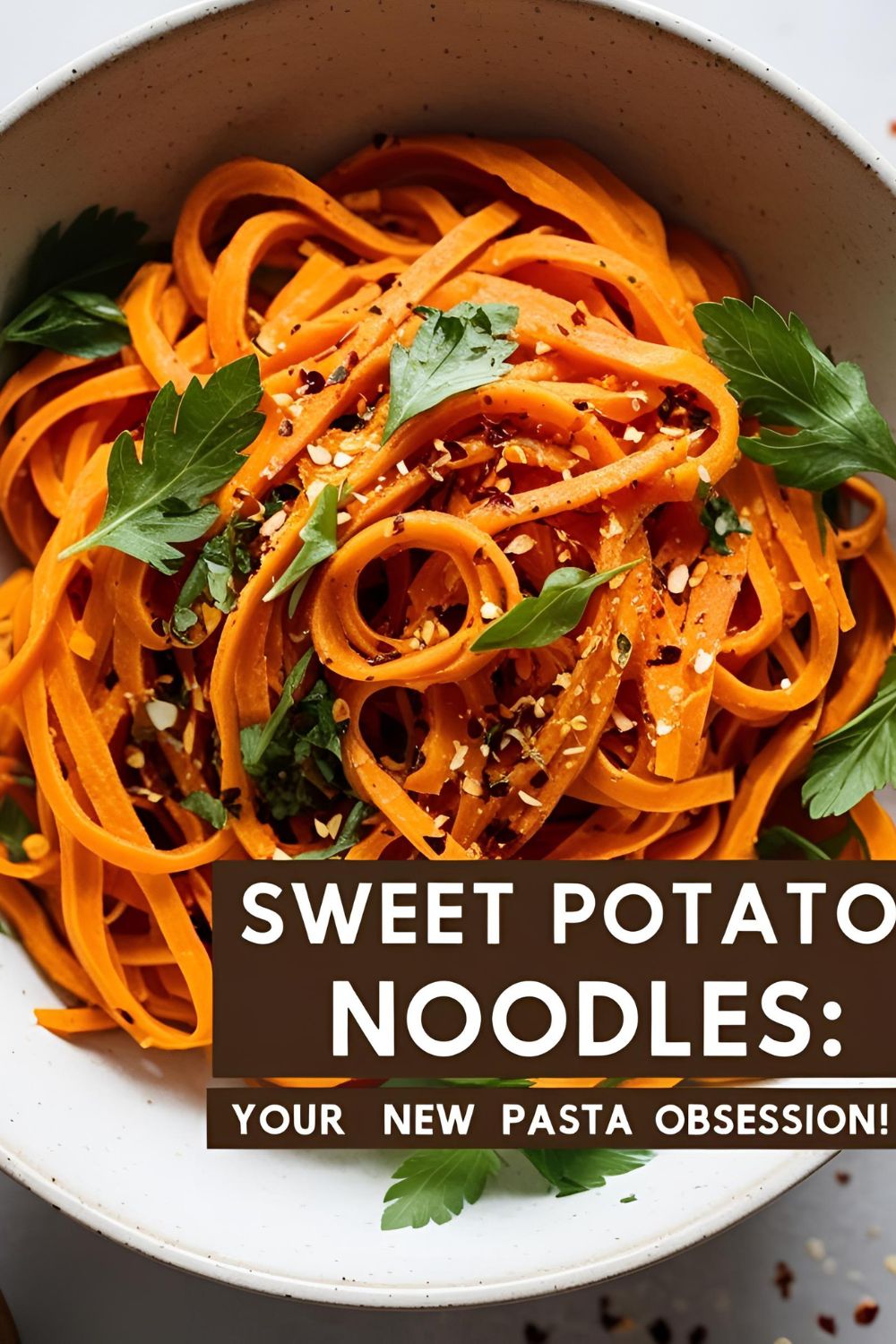 A bowl of sweet potato noodles garnished with fresh herbs and chili flakes.