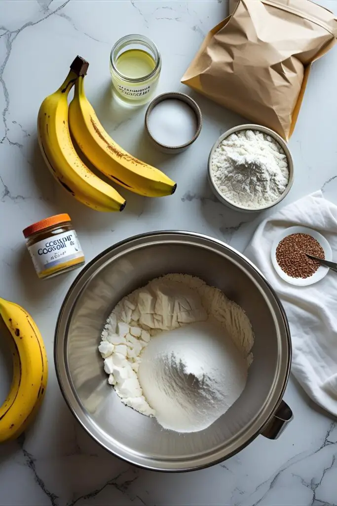 Whole vegan banana bread loaf with parchment and bananas