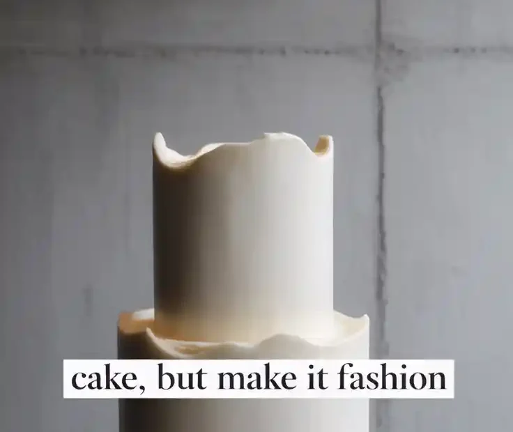 A Pinterest pin with the text "CAKE, BUT MAKE IT FASHION" over a photo of a minimalist, stark white cake.