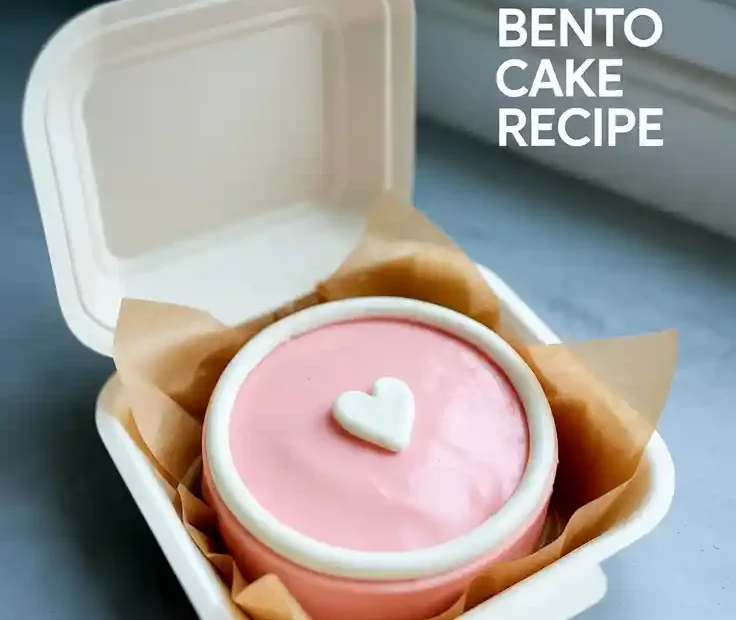 A cute pink bento cake in a takeout box with a simple heart design, with the text "Pink Bento Cake Recipe" overlaid.