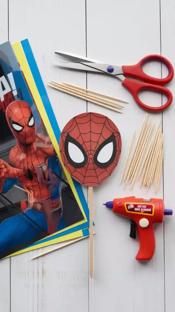  A collage of supplies for a DIY Spiderman cake topper, including cardstock, scissors, and glue.