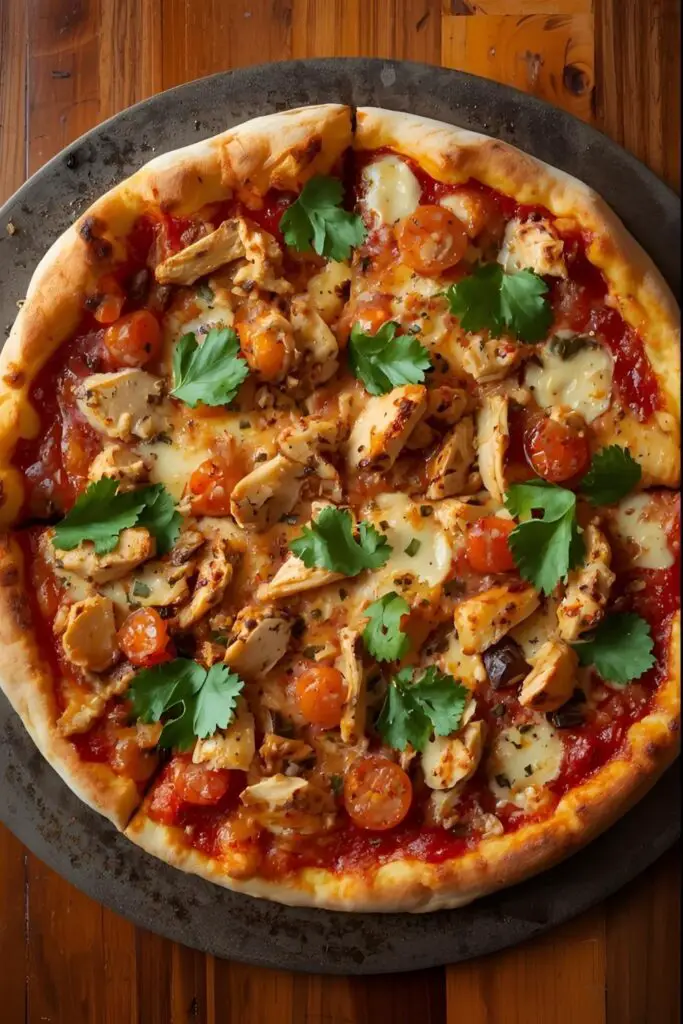 A close-up of a slice of BBQ chicken pizza being pulled away from a whole pizza.