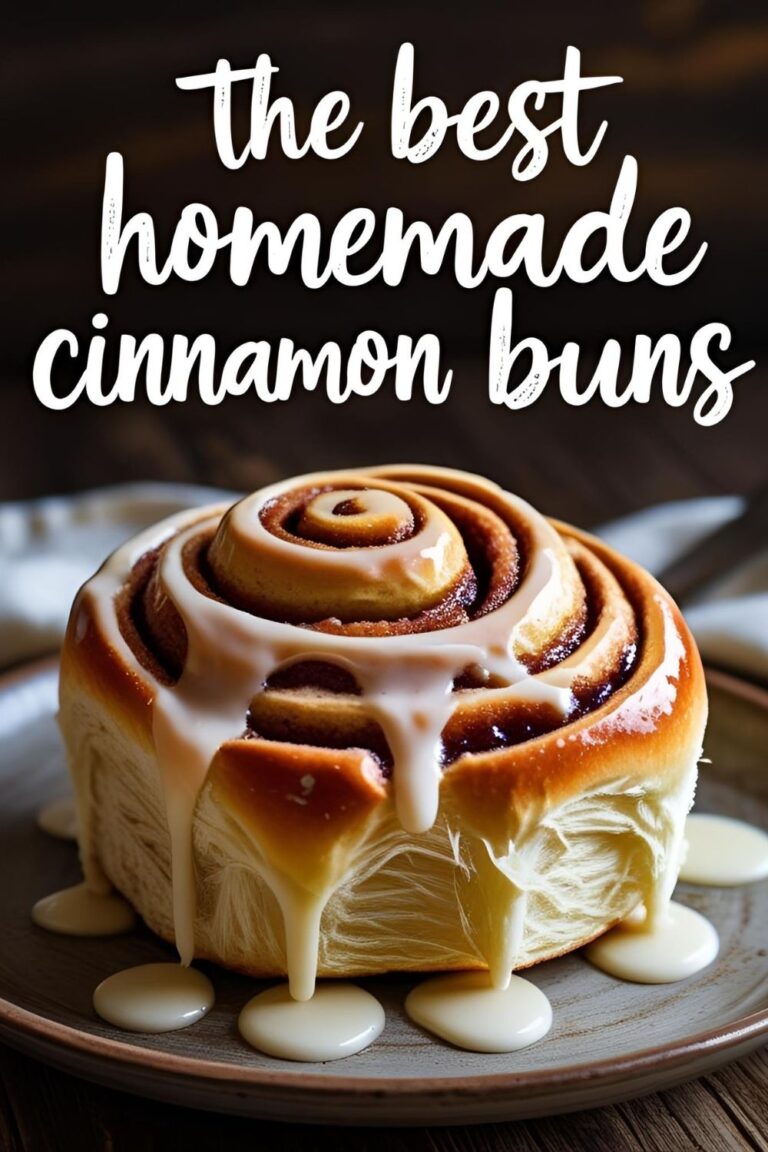A beautiful homemade cinnamon bun drizzled with white glaze, with the text overlay "The Best Homemade Cinnamon Buns."