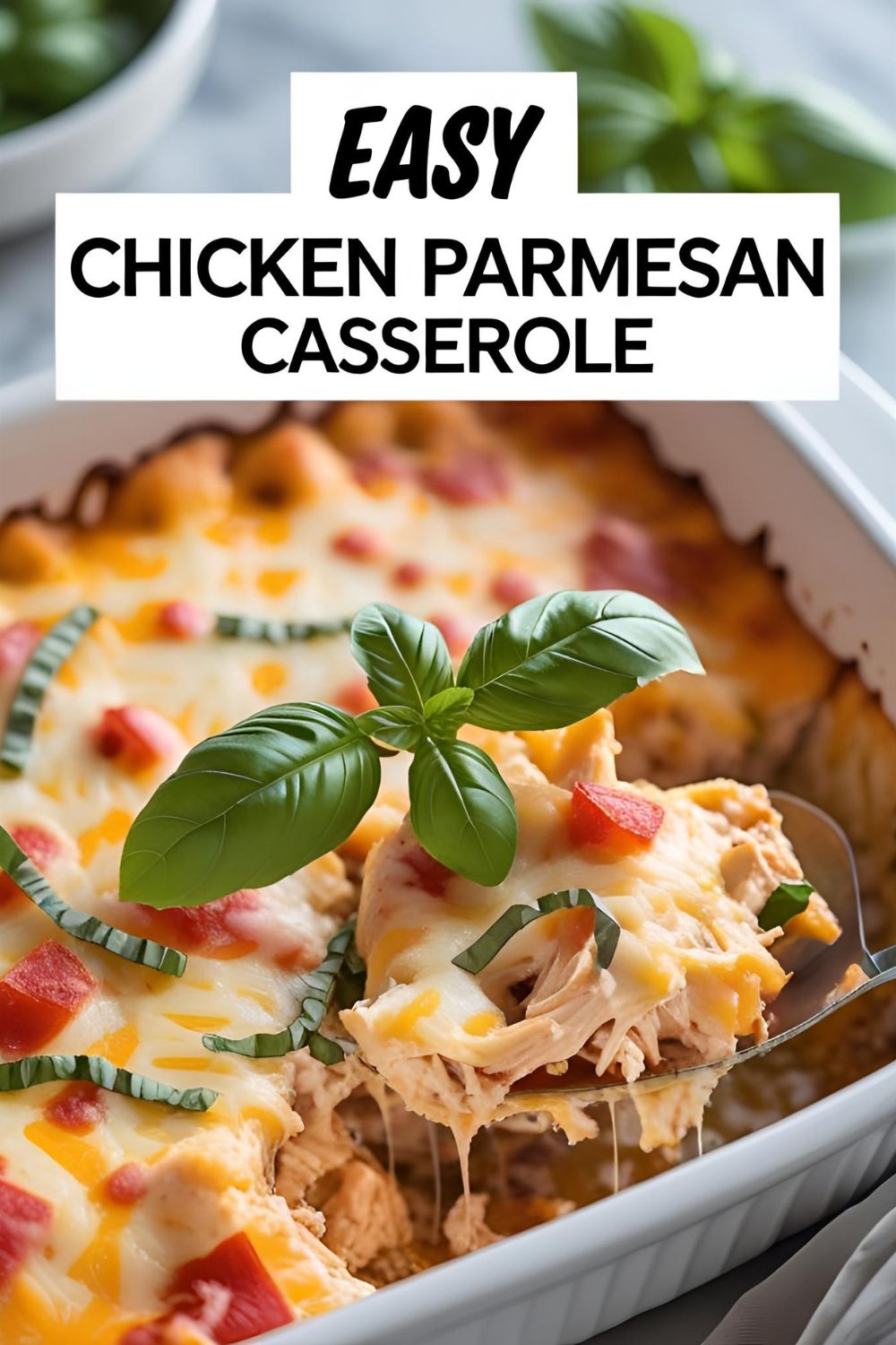Text Overlay: "EASY CHICKEN PARMESAN CASSEROLE" on a mouth-watering image of the golden-brown casserole fresh out of the oven.