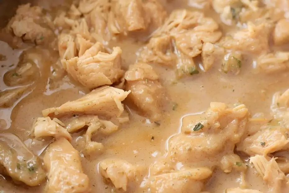 A serving of creamy crockpot chicken and gravy with the text "Crockpot Chicken and Gravy."