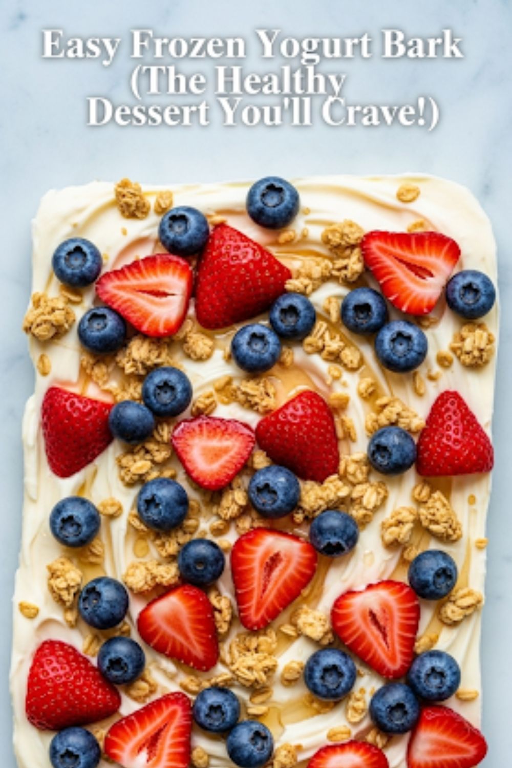 Text overlay "The Ultimate Greek Yogurt Dessert" over a vibrant, colorful, top-down shot of a sheet of frozen Greek yogurt bark broken into pieces, revealing berries, nuts, and chocolate.