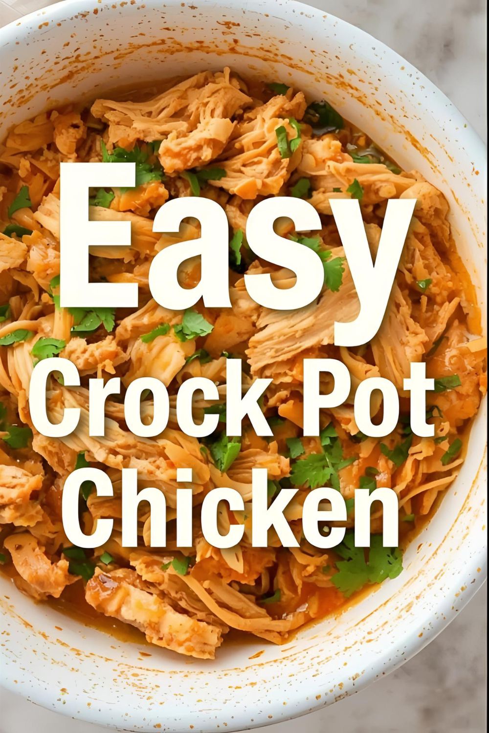 A bowl of juicy shredded crock pot chicken garnished with parsley, with the text overlay "Easy Crock Pot Chicken."