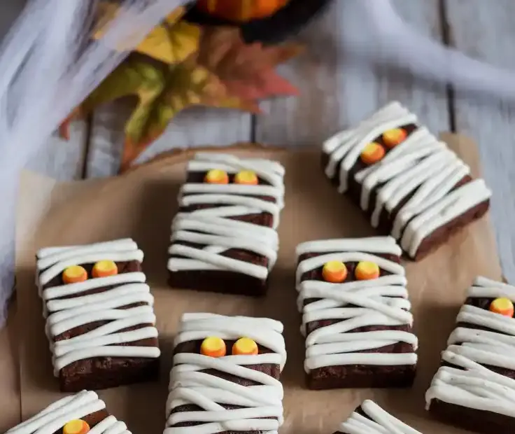 A fun and spooky tray of mummy brownies, a perfect example of easy Halloween baking ideas.