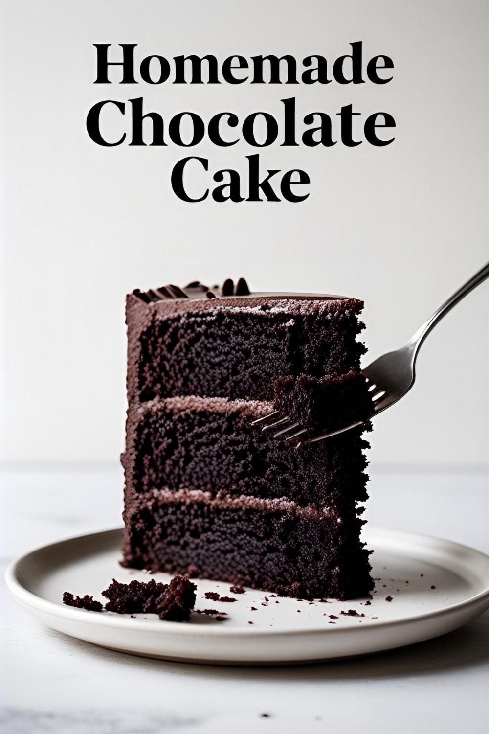 A decadent slice of homemade chocolate cake with the text overlay "The Best Homemade Chocolate Cake."