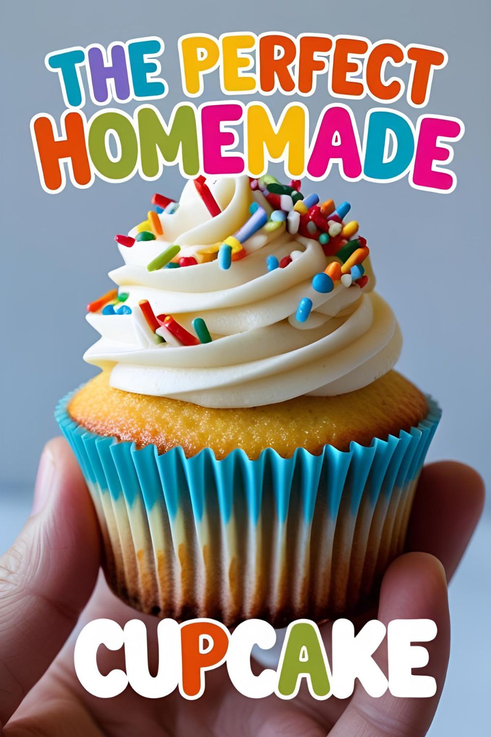 A hand holding a perfectly frosted homemade vanilla cupcake with a swirl of buttercream and colorful sprinkles.