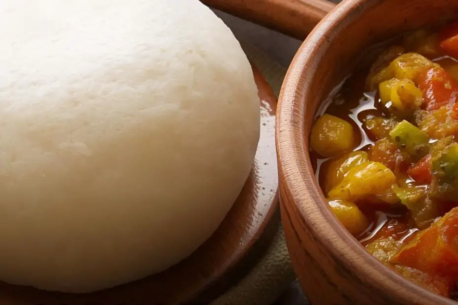 Text overlay "How to Make Fufu" over a beautiful image of a perfectly smooth, round ball of fufu in a bowl next to a vibrant soup.