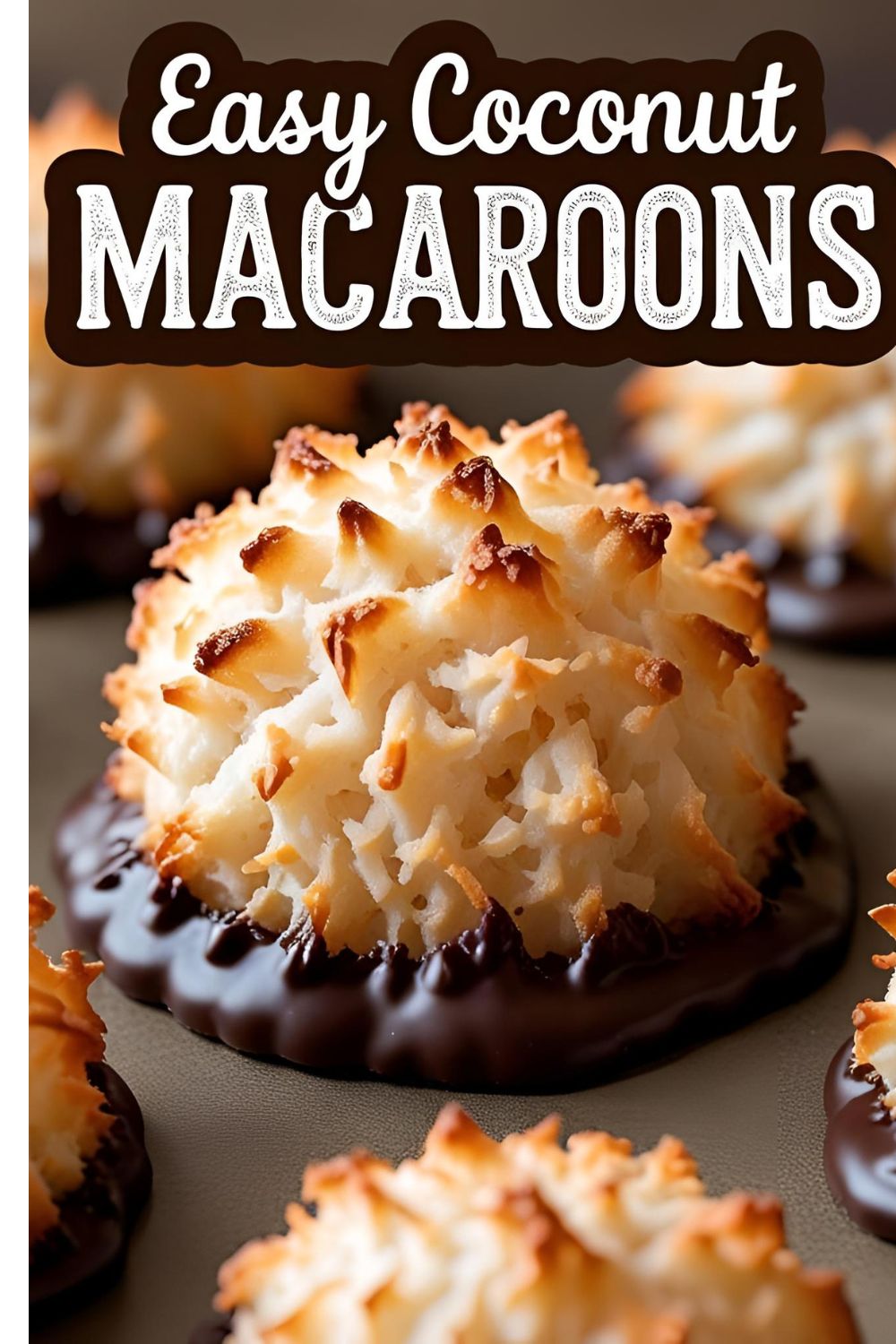 A perfectly baked, golden-brown coconut macaroon with its base dipped in dark chocolate, sitting on parchment paper.