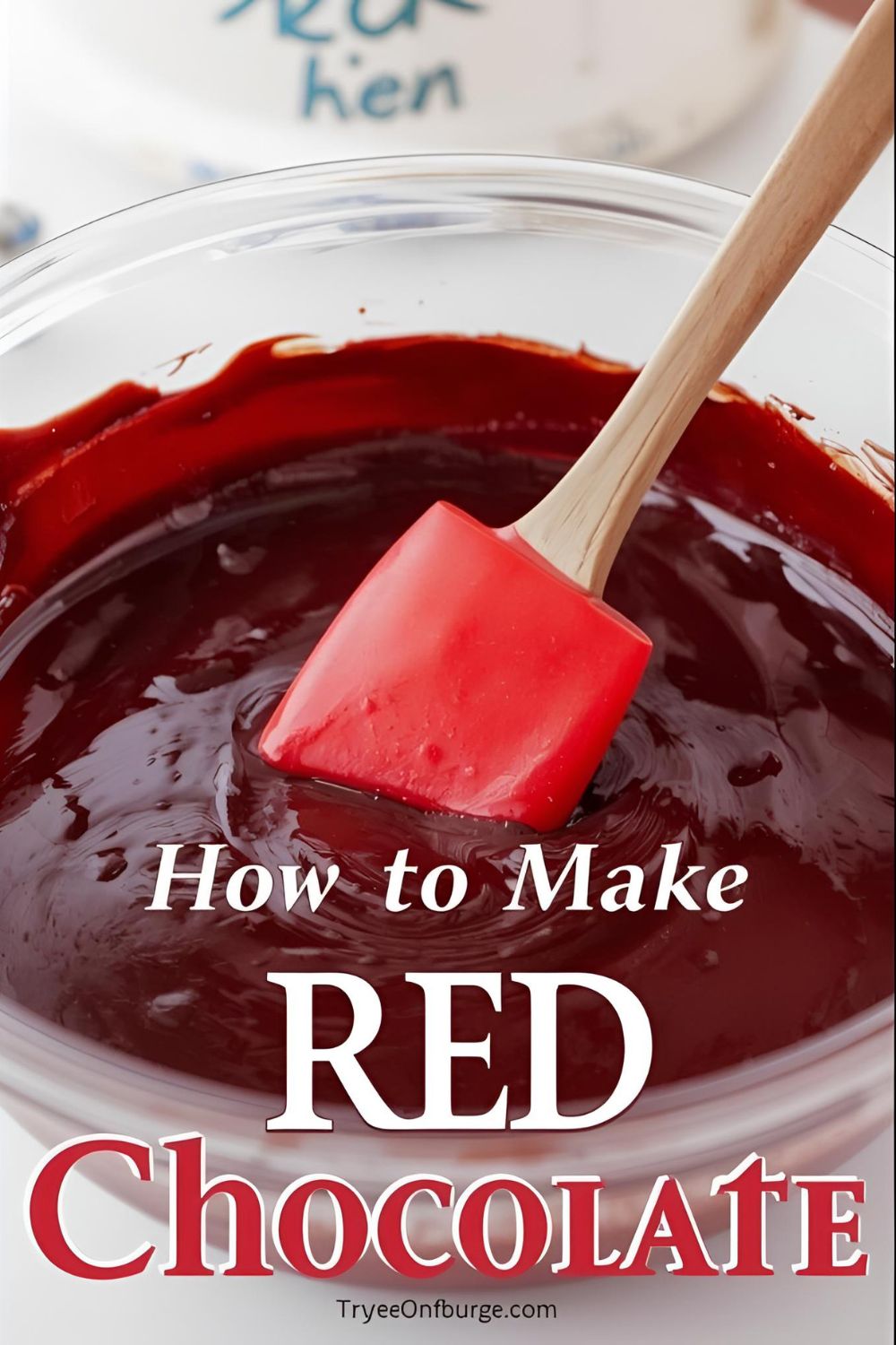 A close-up of a perfectly formed shiny red chocolate heart
