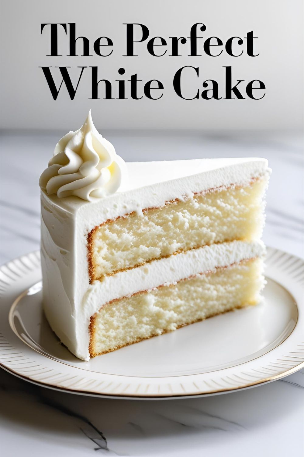 A pristine slice of homemade white cake with white frosting, showing the perfectly white and tender crumb.