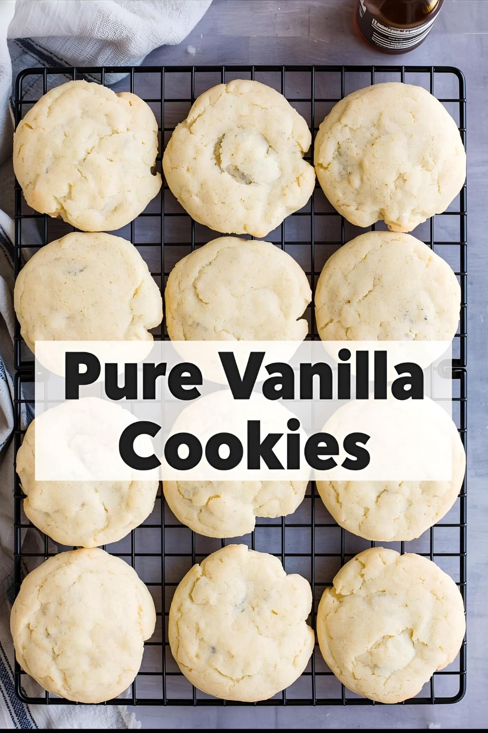 Text overlay "pure vanilla cookies" on a background image of perfectly pale, soft cookies on a cooling rack, with a bottle of vanilla extract nearby.